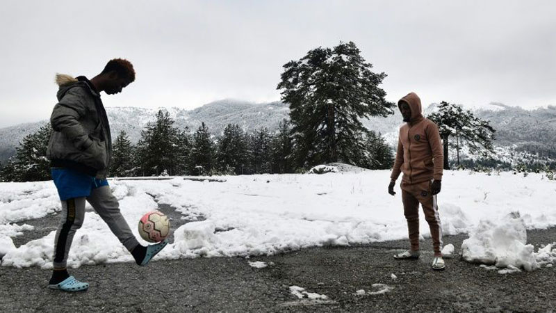 Stuck in Greek snow, refugees already miss dismal camps
