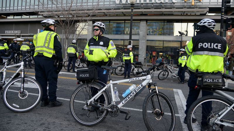 Masked white nationalists march in Washington with police escort