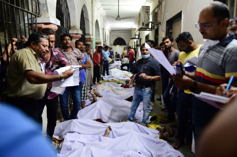 Families line up to bury dead from India bridge collapse