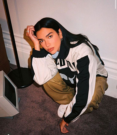 Dua Lipa unveils Puma's new lookbook in chic plunging leather jacket ...